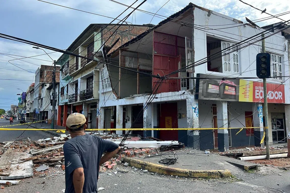 A man standing in front of a house damaged by an earthquake that struck the city of Esmeraldas, in Ecuador, on April 25.
