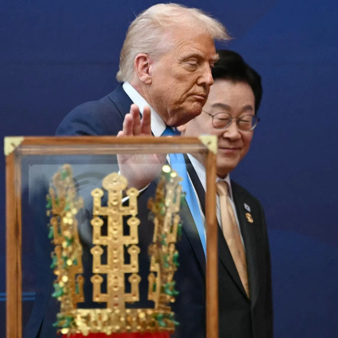 US President Donald Trump walks with South Korean President Lee Jae Myung during a high honor presentation ceremony, where Trump was presented with a replica of a crown worn by the kings of Silla, at the Gyeongju National Museum in Gyeongju on October 29, 2025. (Photo by ANDREW CABALLERO-REYNOLDS / AFP)