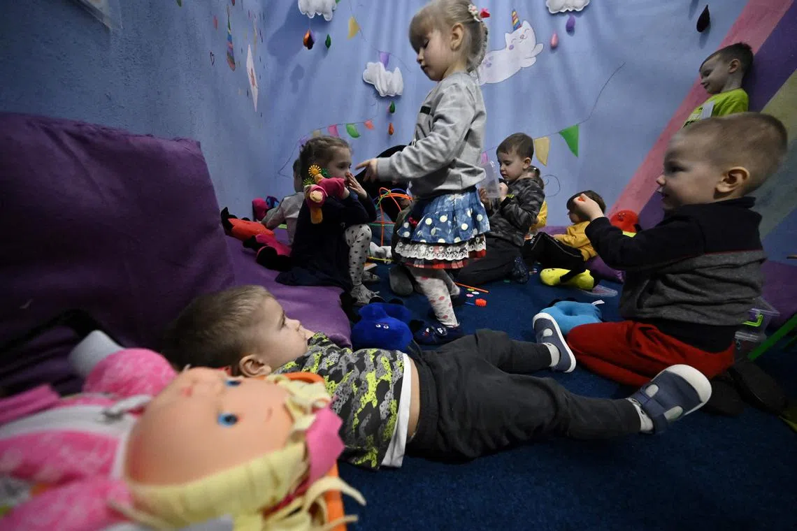 Children play in an air-raid shelter in the cellar of a kindergarten after an alarm signal in Kyiv on March 20.