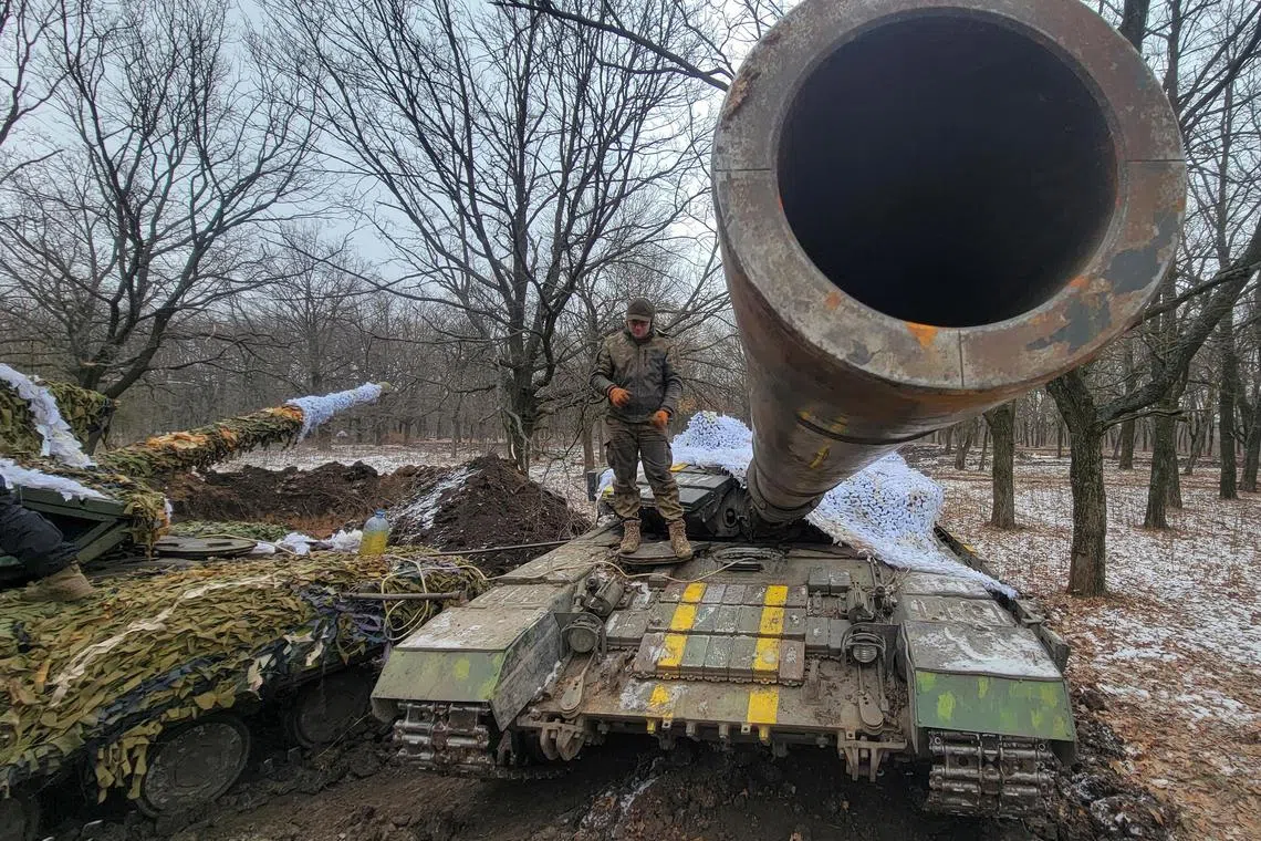 A Ukrainian serviceman stands on a tank near the front-line town of Bakhmut, in Ukraine's Donetsk region, on Jan 13, 2022.