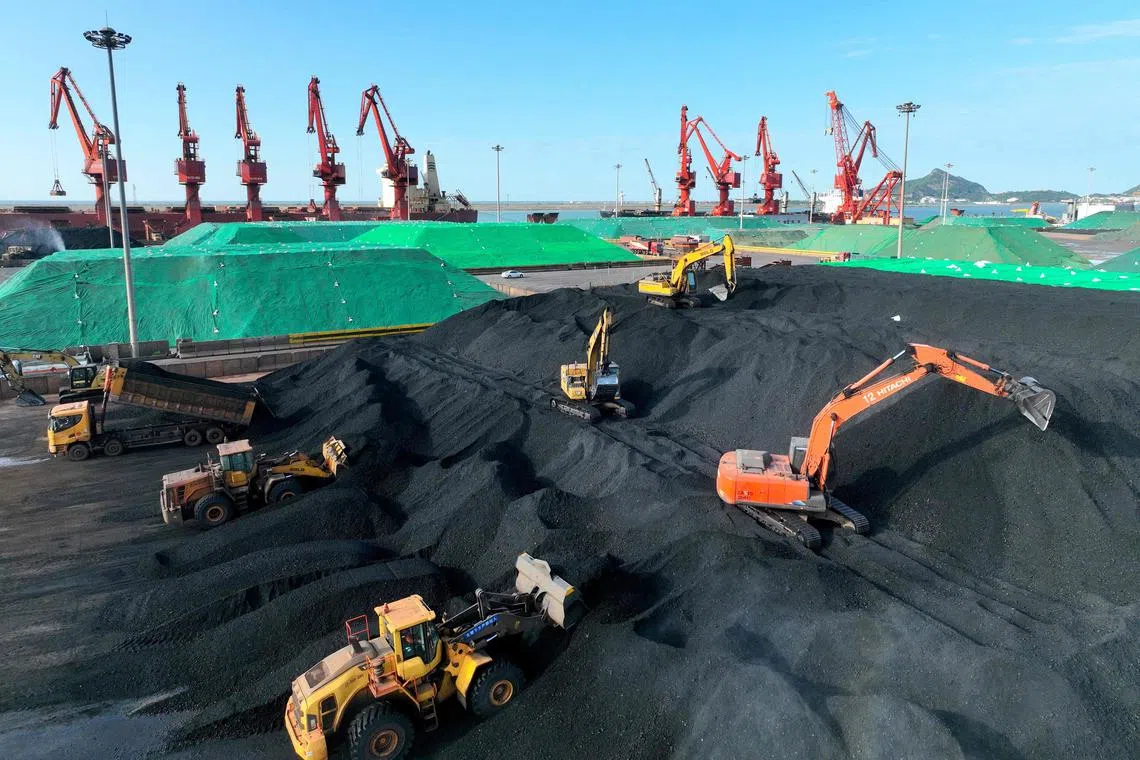 Excavators transferring coal at a port in Lianyungang, in China's eastern Jiangsu province.