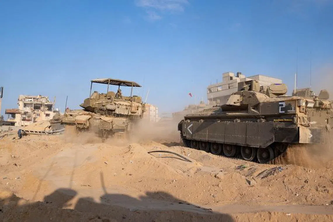 Israeli military vehicles manoeuvre amid the ongoing ground operation of the Israeli army against the Palestinian Islamist group Hamas, in the Gaza Strip, in this handout image released by the Israel Defense Forces on November 8, 2023. Israel Defense Forces/Handout via