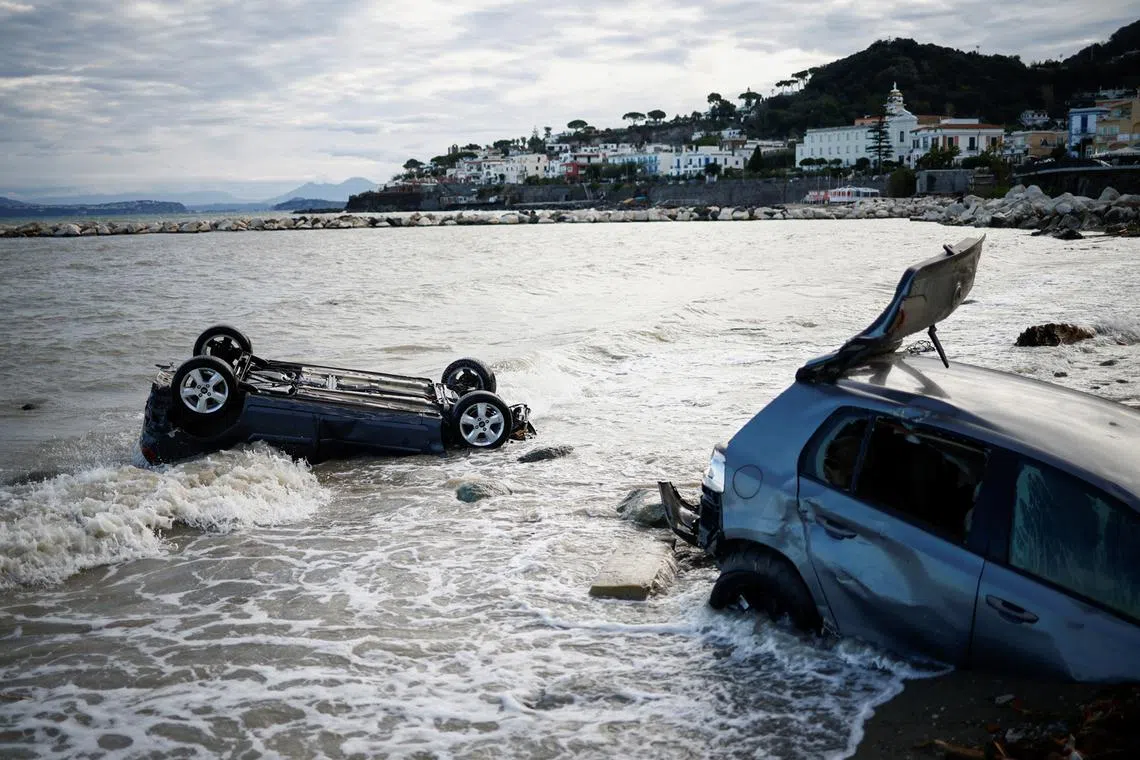 Damaged cars are seen in the sea, following a landslide on the Italian holiday island of Ischia, Italy, Nov 27, 2022. 