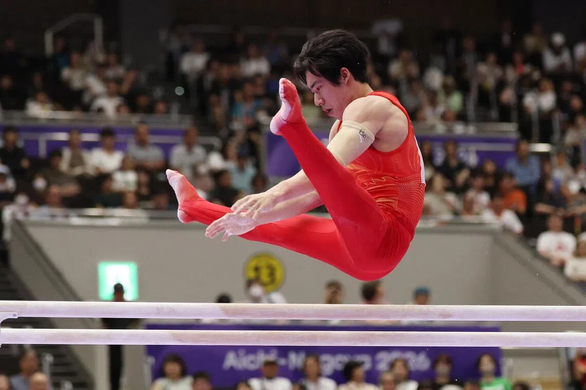 China’s Zhang Boheng performing his routine on the parallel bars en route to winning the men’s all-around gymnastics gold at the Asian Games in Japan on Sept 21.
