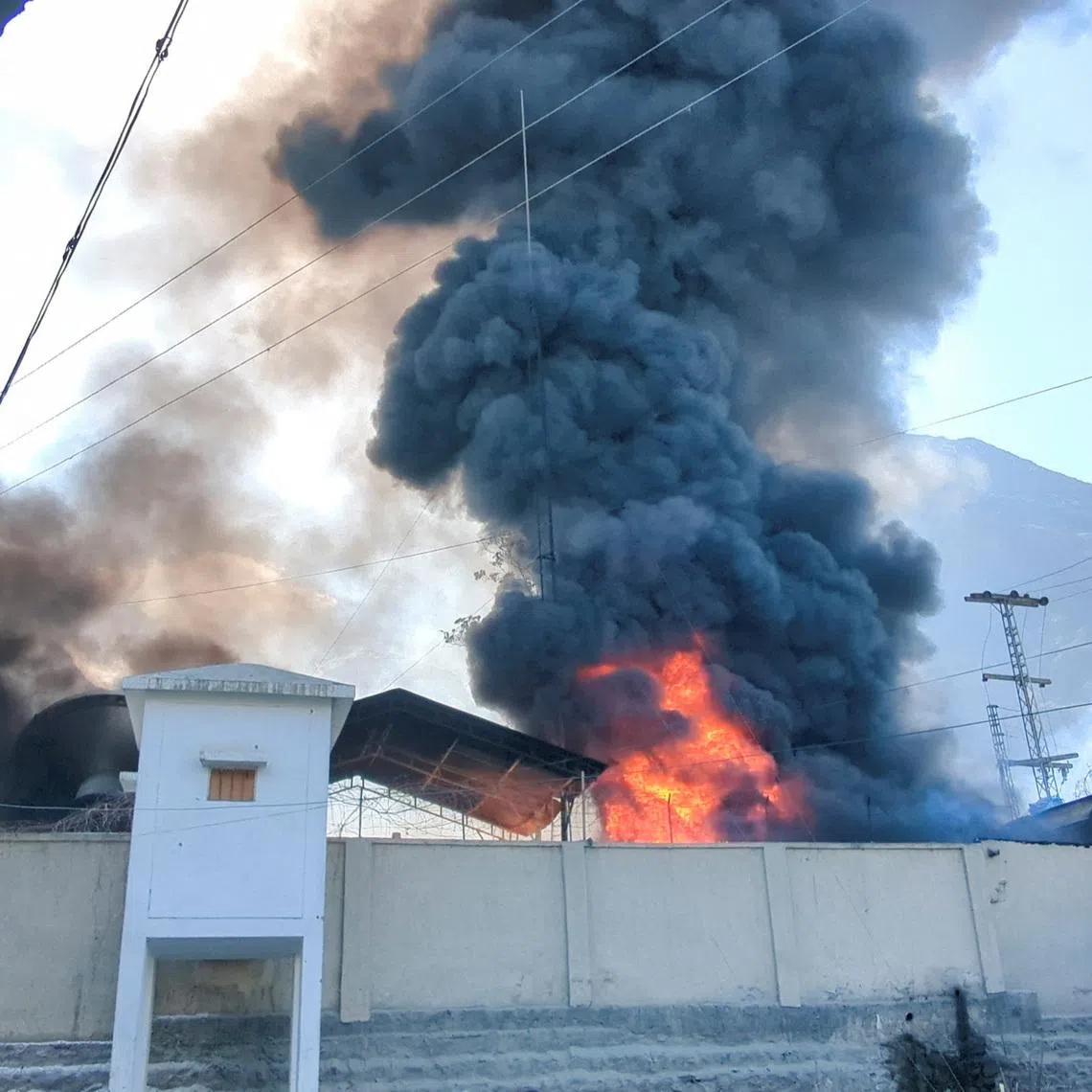 Smoke and flames rise from the premises of the U.N. office, after it was set ablaze by protesters, following news of U.S. and Israeli strikes on Iran that killed supreme leader Ayatollah Ali Khamenei, in the city of Gilgit, Gilgit Baltistan, Pakistan March 1, 2026. Picture taken with a mobile phone. REUTERS/Mubarak Hussain