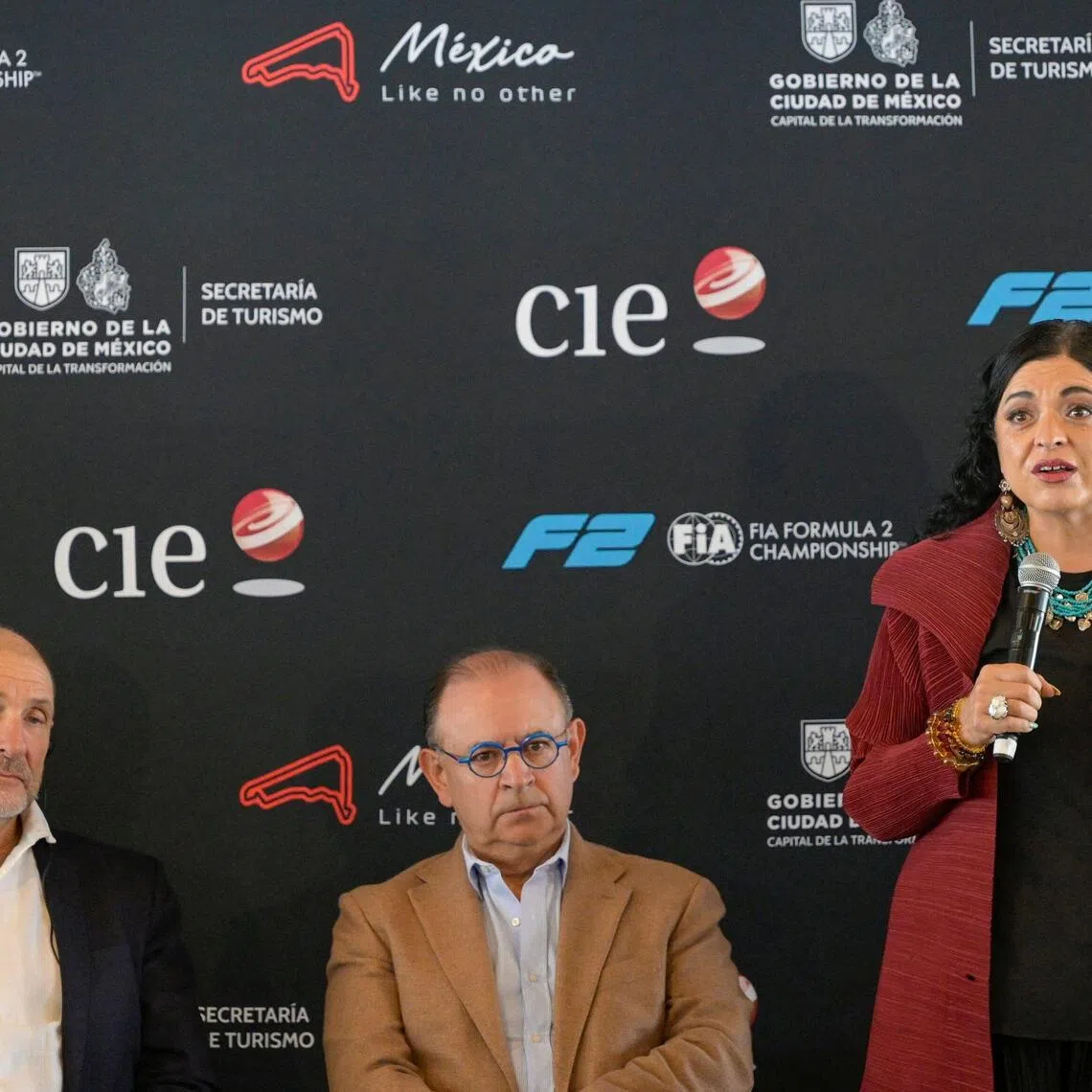 Mexico City Tourism Secretary Alejandra Fraustro (R) speaks alongside Bruno Michel (L), Chief Executive Officer (CEO) of the FIA Formula 2 and Formula 3 Championships, and Federico Gonzalez Compean (C), CEO of the Formula One Mexico City Grand Prix, during the announcement of a Formula 2 race in Mexico City as part of the 2027 calendar at the Autodromo Hermanos Rodriguez in Mexico City on October 5, 2026. (Photo by Alfredo ESTRELLA / AFP)