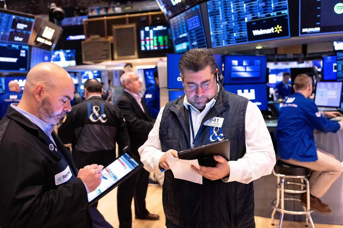 Traders working on the floor of the New York Stock Exchange, during morning trading, on March 25.