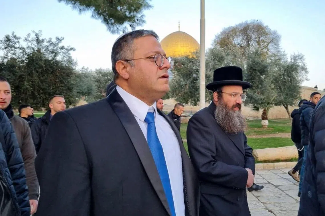 A handout picture courtesy of the Minhelet Har-Habait (Temple Mount Administration) shows Israeli minister Itamar Ben-Gvir (centre) walking through the courtyard of Jerusalem's Al-Aqsa mosque compound.