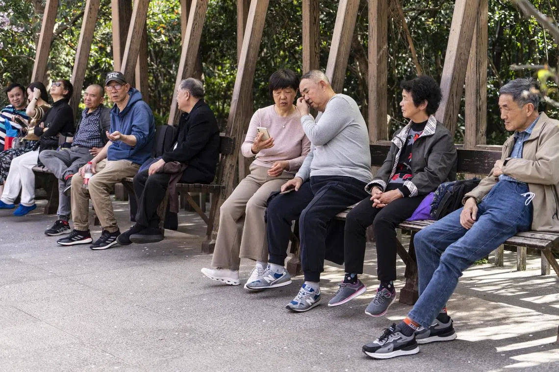 Socializing in People's Park, known for its matchmaking corner, in Shanghai, March 30, 2024. The park, known for attracting parents seeking matches for their unwed children on weekends, also now thrives as a social hub for seniors. (Qilai Shen/The New York Times) 