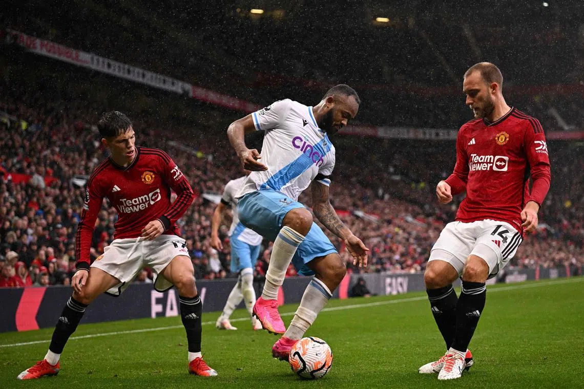 Crystal Palace striker Jordan Ayew in action with United's Alejandro Garnacho and Christian Eriksen.