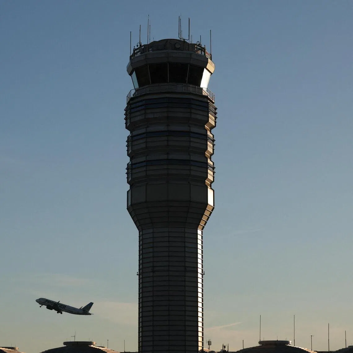 The control tower stands at Ronald Reagan Washington National Airport as a plane takes off on Oct 27, 2025 in Arlington, Virginia.