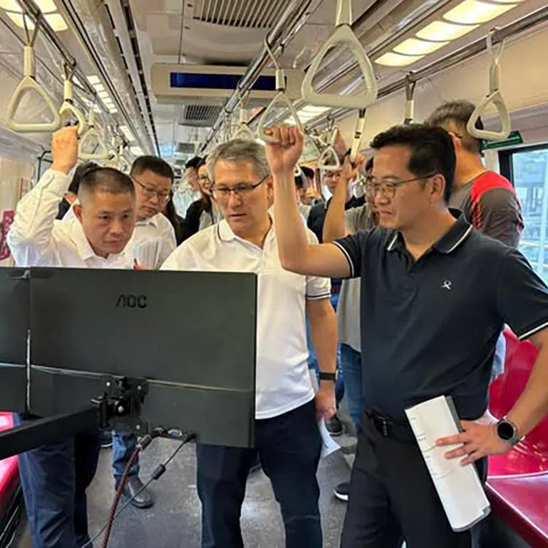 Staff from the Land Transport Authority, SMRT and Chinese signalling firm CASCO on a train where the backup signalling system is being tested.