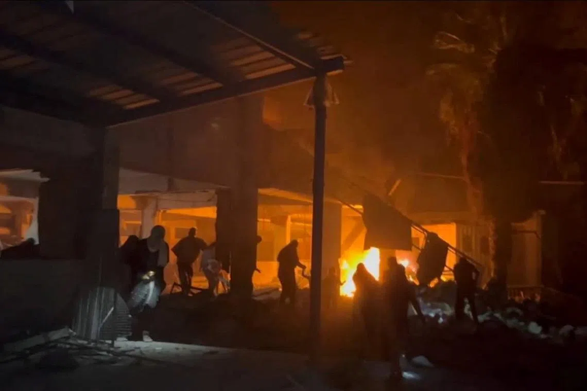 Palestinians react at the site of an Israeli strike on a school in Al- Shati (beach) refugee camp, amid Israel-Hamas conflict, in Gaza City June 25, 2024. REUTERS/Reuters TV
