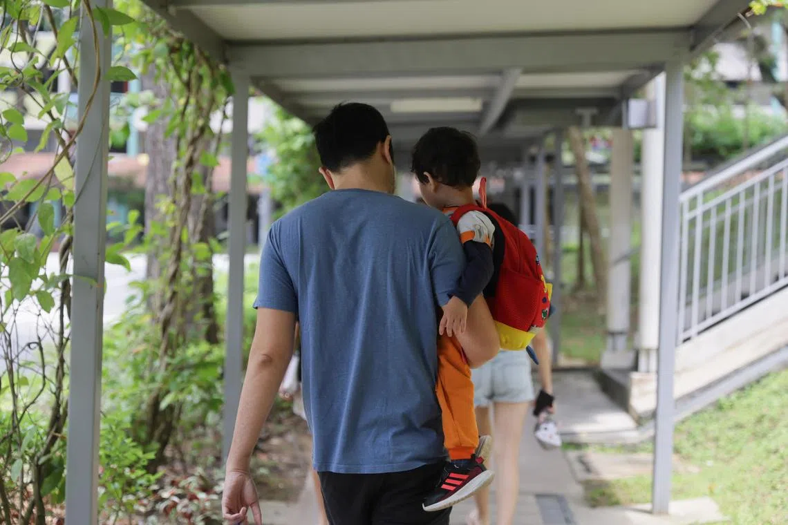 A father carrying his preschooler child at Tiong Bahru, 24 October 2023. Can use for stories on parenting, fatherhood, family, family planning, childcare, single parent,
