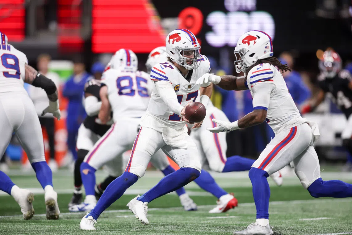 Oct 13, 2025; Atlanta, Georgia, USA; Buffalo Bills quarterback Josh Allen (17) hands off to running back James Cook (4) during the second half of a game against the Atlanta Falcons at Mercedes-Benz Stadium. Mandatory Credit: Brett Davis-Imagn Images