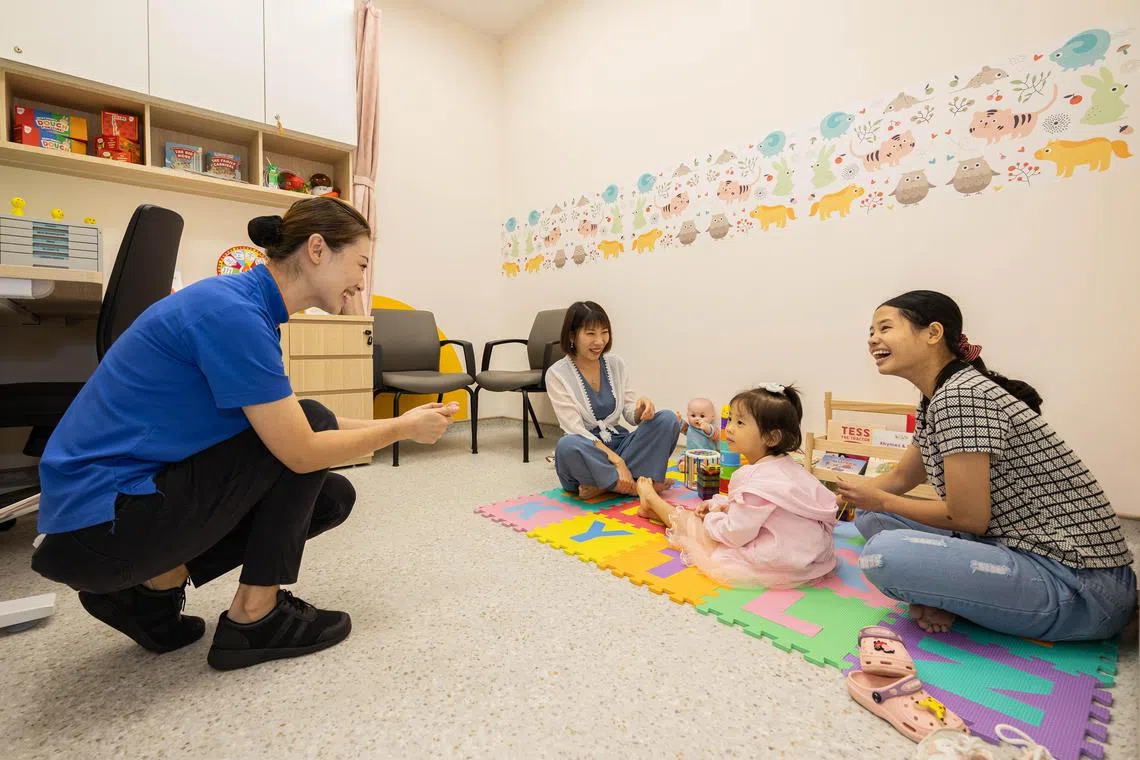 Nurse Clinician Han Tian Yu (left) with Ms Yan Yue Mei (centre) in the Nurture Consultation Room at FamNex@OTH on June 14.