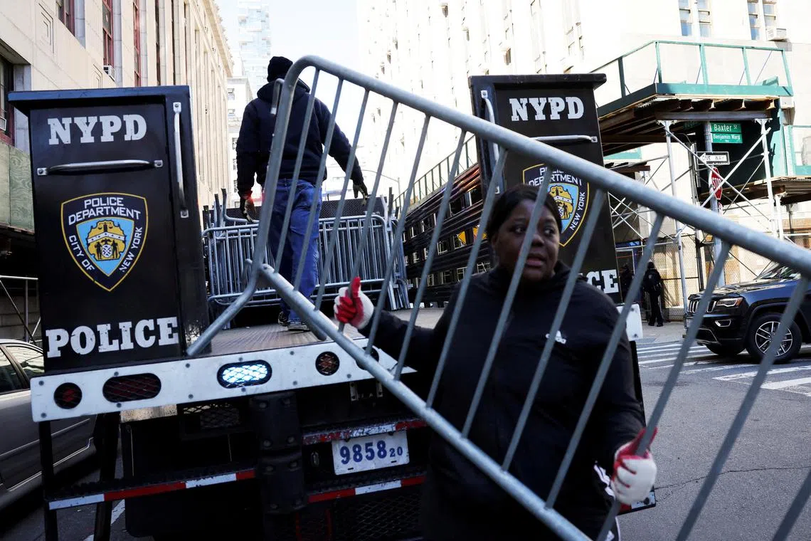 New York City police have thrown up metal barriers around Trump Tower and blocked roads near Manhattan Criminal Courthouse.