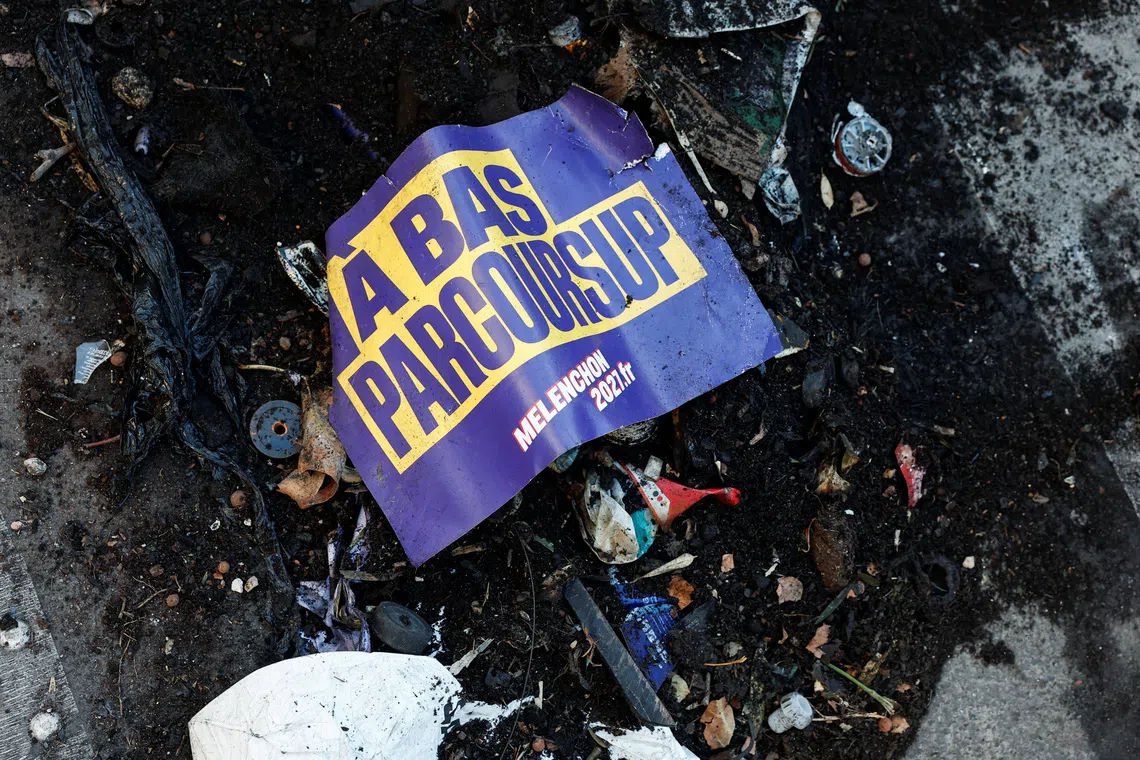 Image 3: A placard supporting Jean-Luc Melenchon, leader of the French far-left opposition party La France Insoumise (France Unbowed - LFI) and a candidate for the 2027 French presidential election, lies among debris a day after clashes during a national day of demonstrations against the cost of living and rising fuel prices in Paris, France, October 18, 2026. REUTERS/Benoit Tessier