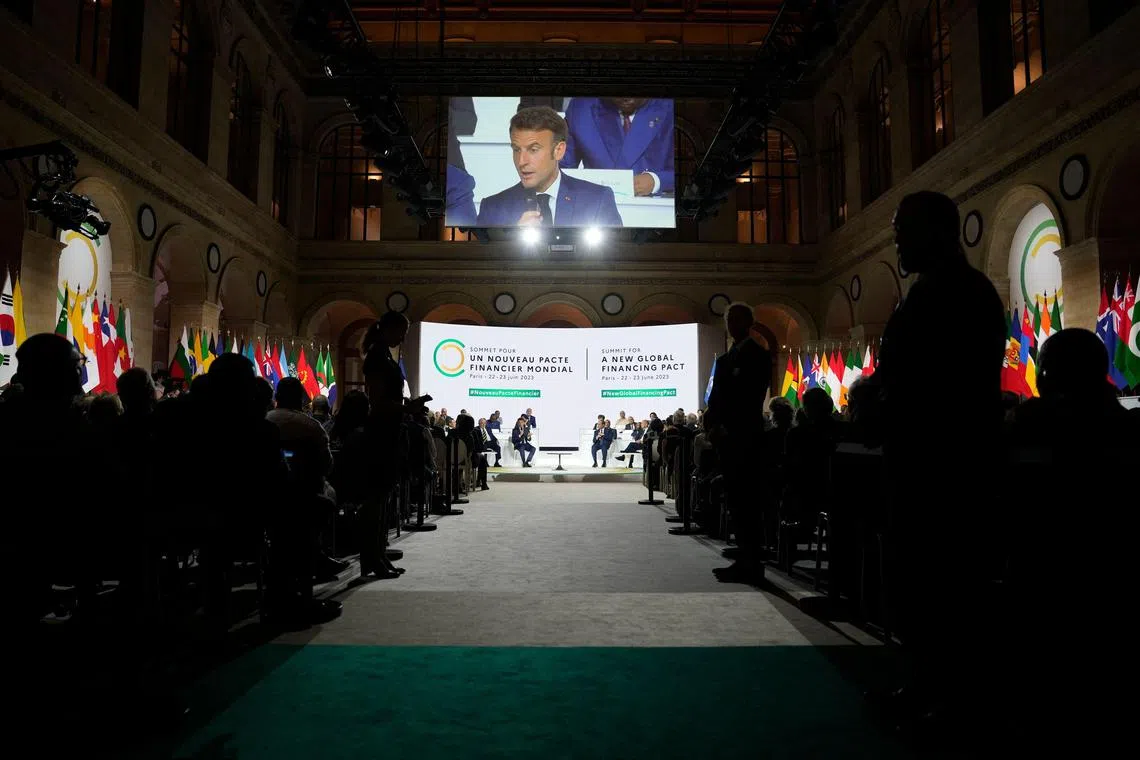 TOPSHOT - French President Emmanuel Macron speaks during the closing session of the New Global Financial Pact Summit, in Paris on June 23, 2023. (Photo by Lewis Joly / POOL / AFP)