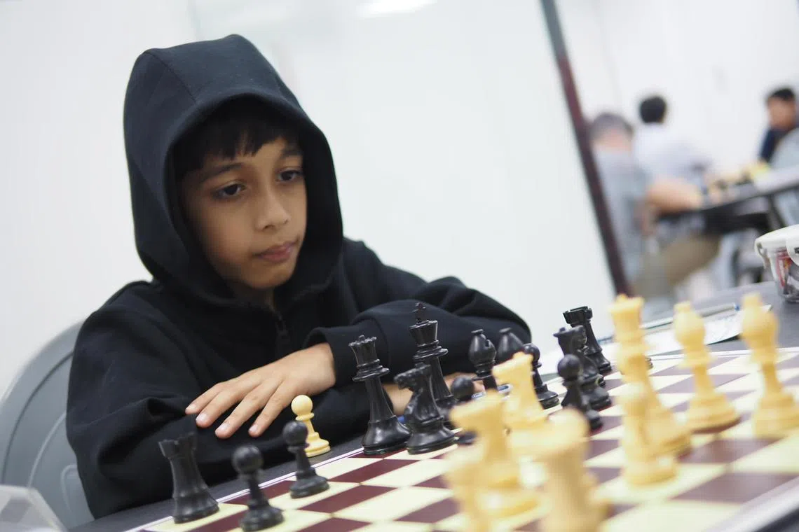 eachess16 - Ashwath Kaushik, 7, had to use a booster cushion to reach the chess board when he was competing in the 2023 Singapore National Chess Championships.


Credit: Singapore Chess Federation