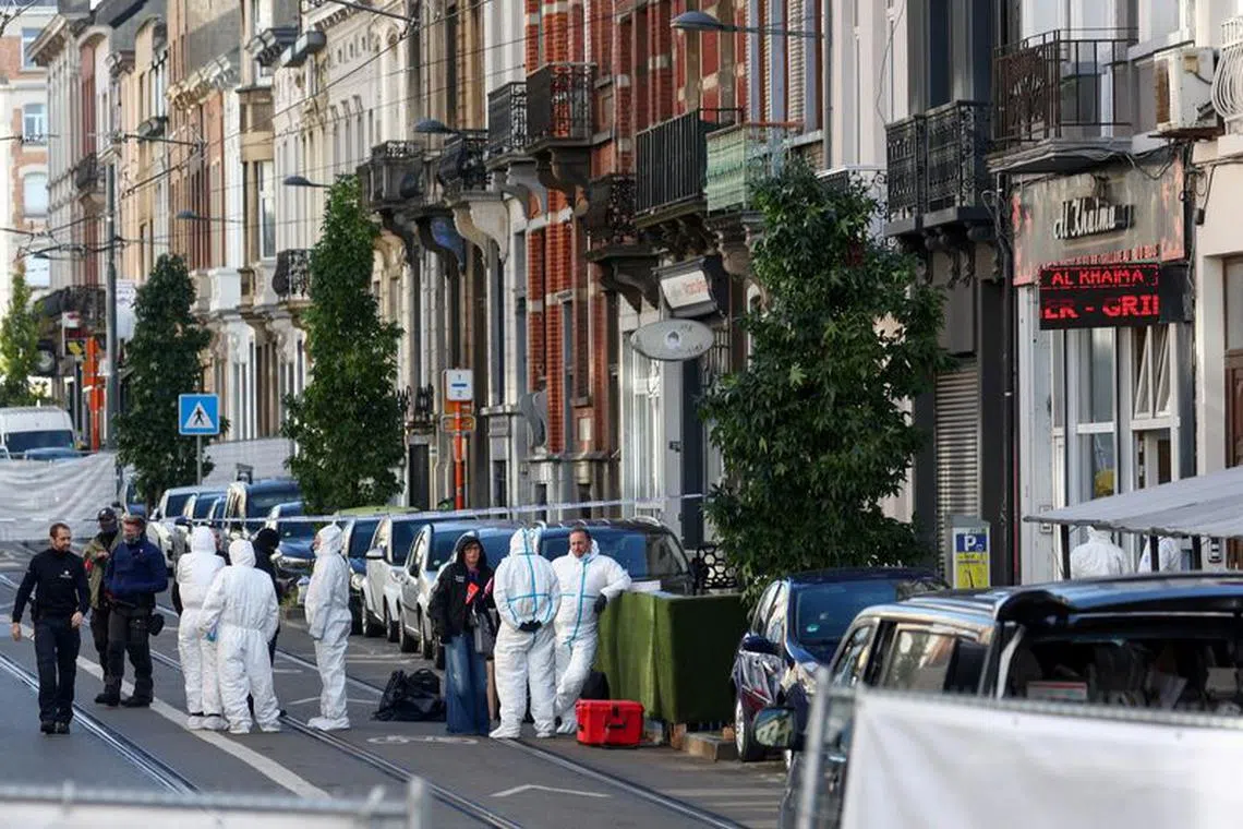 Police officers work outside the site of a police operation against a deadly shooting suspect, in Schaerbeek, Brussels, Belgium, October 17, 2023. REUTERS/Yves Herman