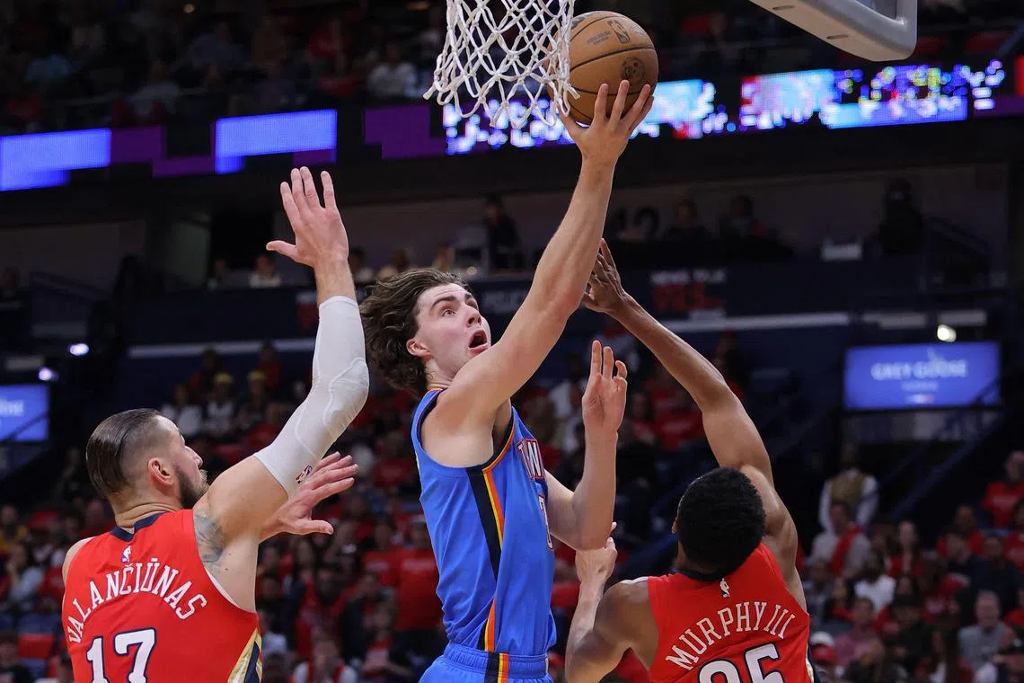 Josh Giddey of the Oklahoma City Thunder shooting against Jonas Valanciunas and Trey Murphy III of the New Orleans Pelicans during the first half at the Smoothie King Centre on Wednesday. The 20-year-old guard recorded 31 points, 10 assists and nine rebounds to help his team win 123-118.