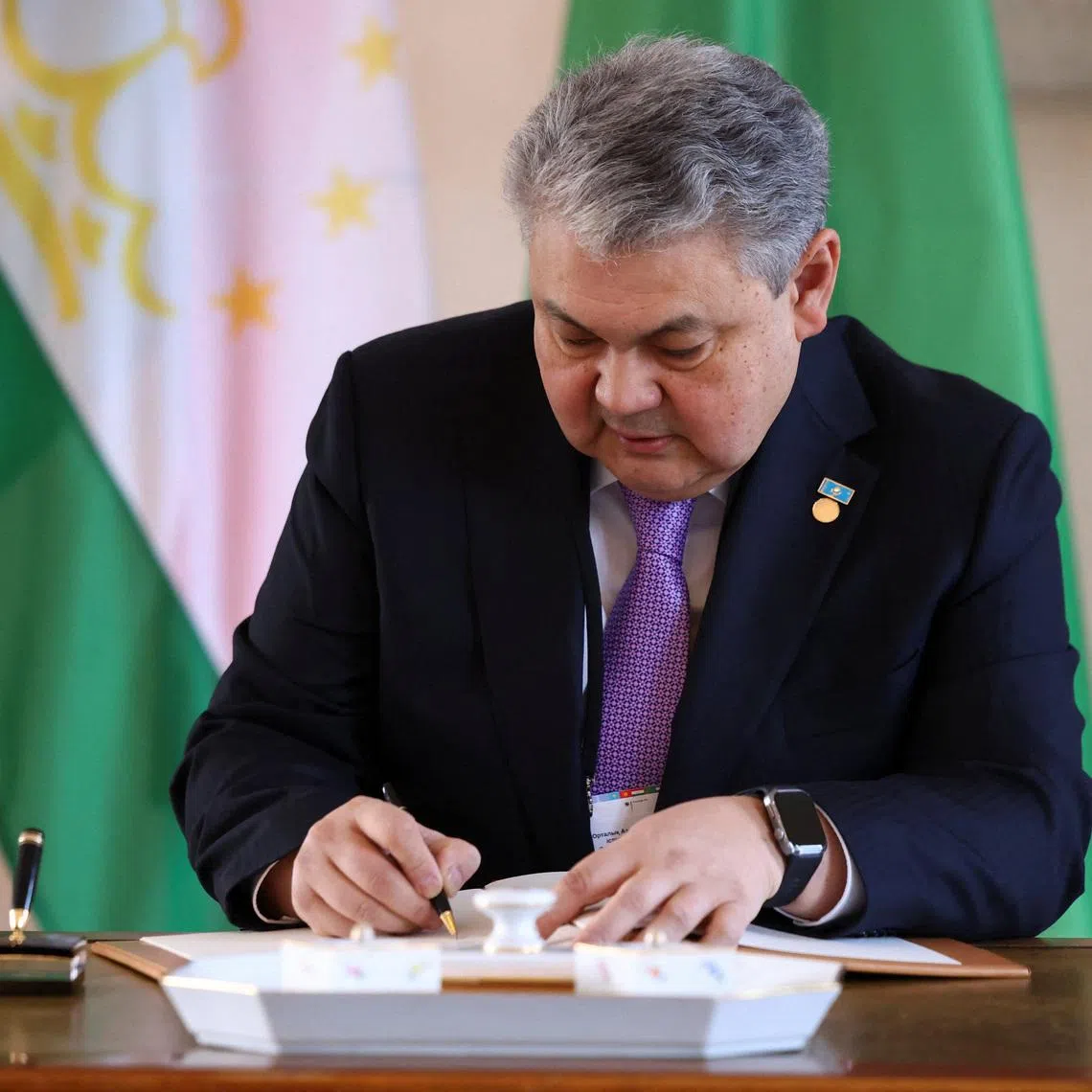 The foreign minister of Kazakhstan, Yermek Kosherbayev, signs a guestbook at Bellevue Palace in Berlin, Germany, February 11, 2026. REUTERS/Christian Mang