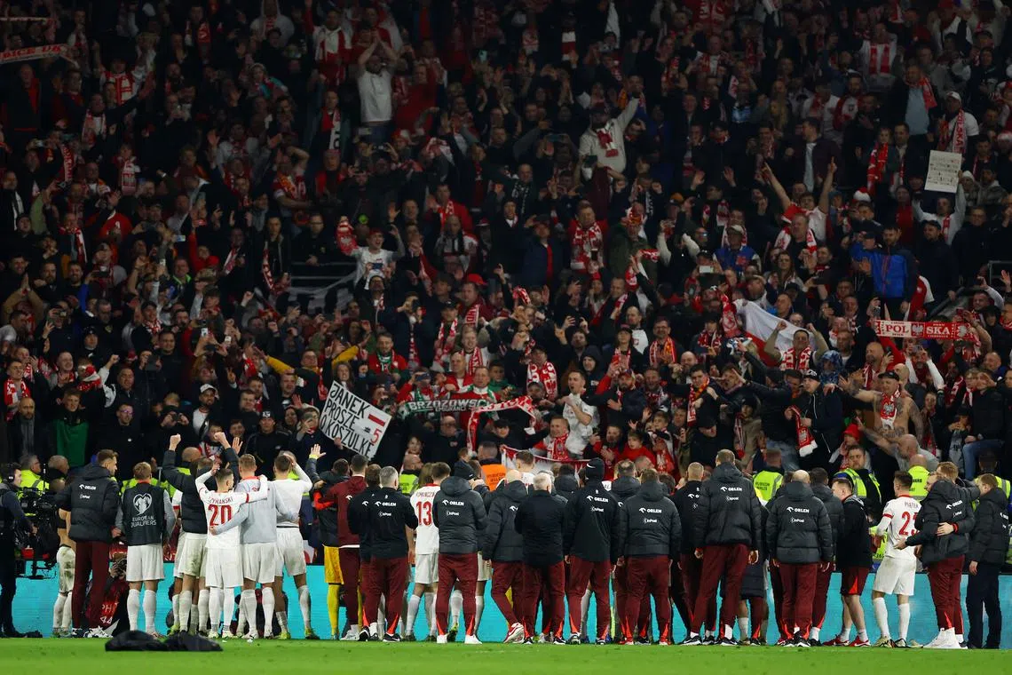 Soccer Football - Euro 2024 Qualifier - Play-Off - Wales v Poland - Cardiff City Stadium, Cardiff, Wales, Britain - March 26, 2024 Poland players and fans celebrate after winning the penalty shootout and qualifying for Euro 2024 REUTERS/Molly Darlington