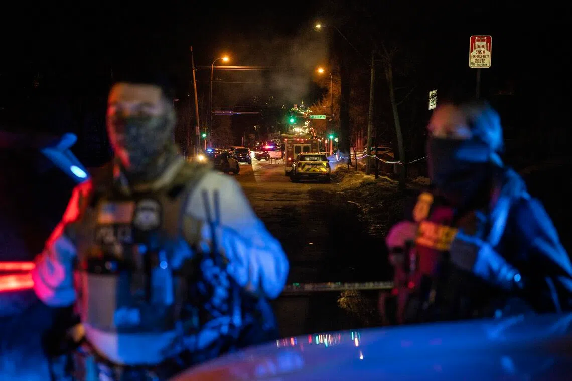 Federal agents near the scene where a federal agent shot a man from Venezuela while trying to detain him in Minneapolis, on Jan 14.