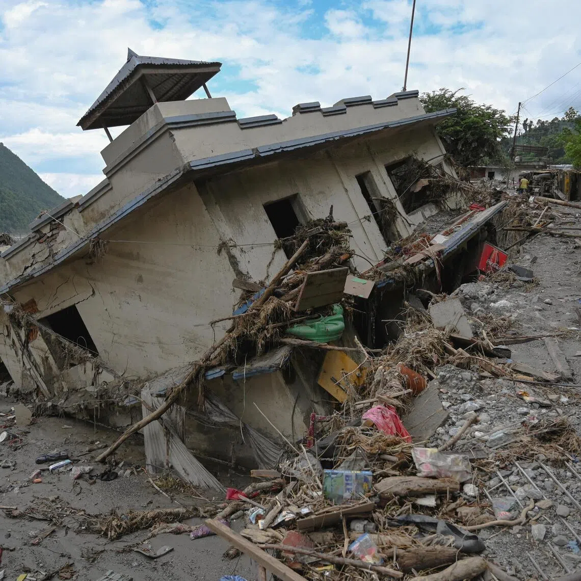 Damaged buildings near Trishuli River following deadly flash floods, in Betrawati Bazaar in Rasuwa district, Nepal, on Aug 30.