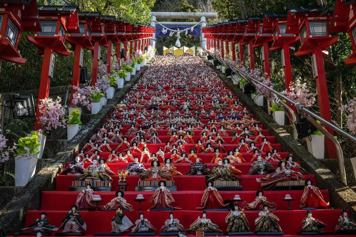 Japanese ornamental dolls (hina dolls) are being displayed on the stone steps at Tomisaki shrine during the Katsuura Big Hinamatsuri festival in Katsuura city of Chiba prefecture on Feb 28, 2023. 