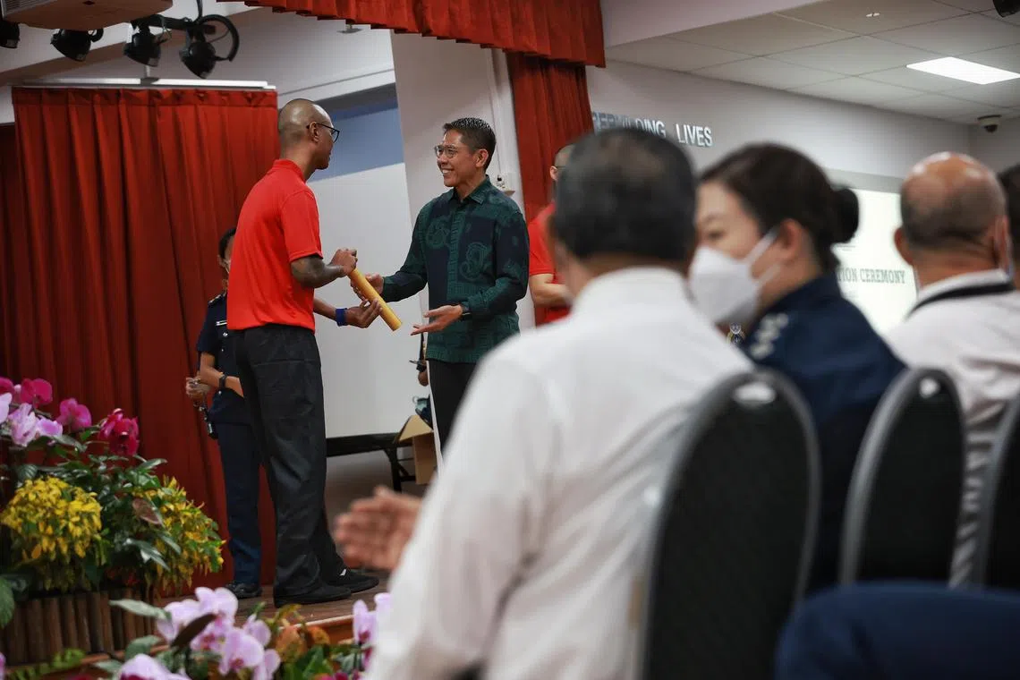 Michael (not his real name) receiving the gold award from Minister in the Prime Minister's Office Maliki Osman at the National Youth Achievement Award (NYAA) Ceremony on Nov 23, 2022. 