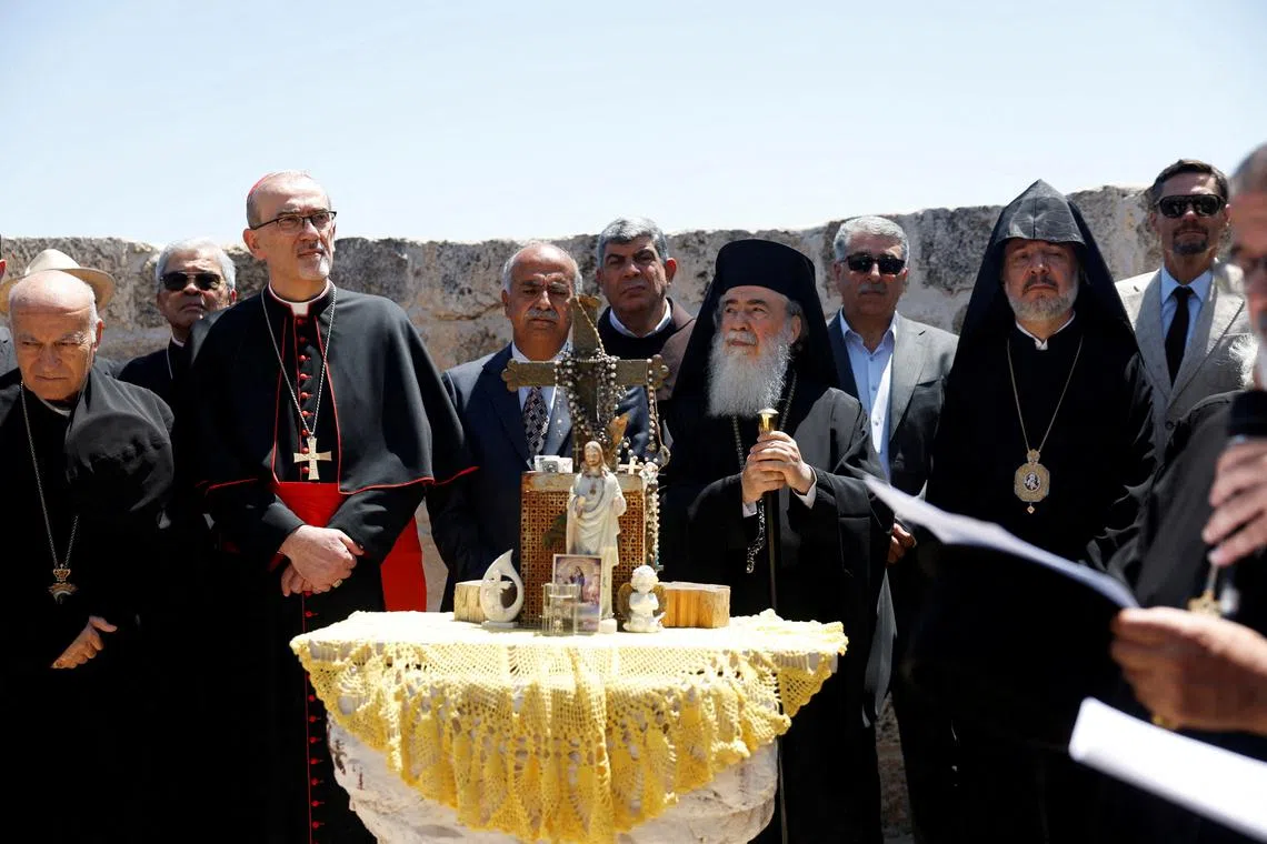 FILE PHOTO: Latin Patriarch in Jerusalem, Pierbattista Pizzaballa, and Greek Orthodox patriarch of Jerusalem, Theophilos III, look on during the visit to the town of Taybeh, a Christian village in the Israeli-occupied West Bank, following settler attacks, July 14, 2025. REUTERS/Mohammed Torokman/File Photo