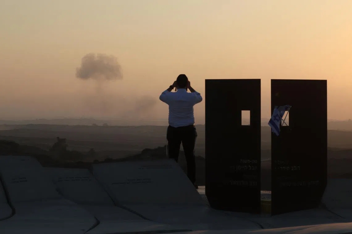 A man on the Israeli side of the border of the Gaza Strip, watching smoke rising following an Israeli airstrike near Beit Hanoun, from Sderot, Israel, on July 21, 2025.  