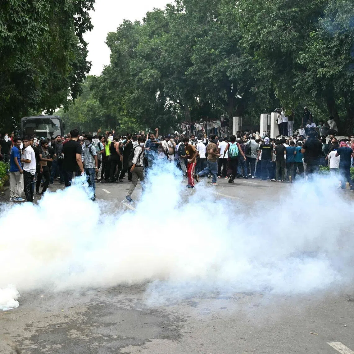 Activists and supporters of the Cockroach Janta Party dispersed after police fired tear gas shells during a protest in New Delhi, on July 20.