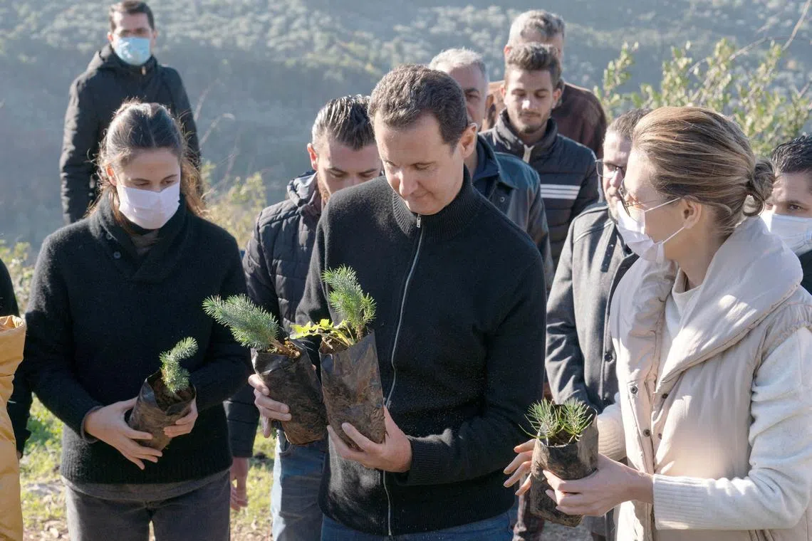 FILE PHOTO: Syria's President Bashar al-Assad and his wife Asma, plant trees in city of Draykish, near Tartous, Syria December 30, 2020. SANA/Handout via REUTERS/File Photo