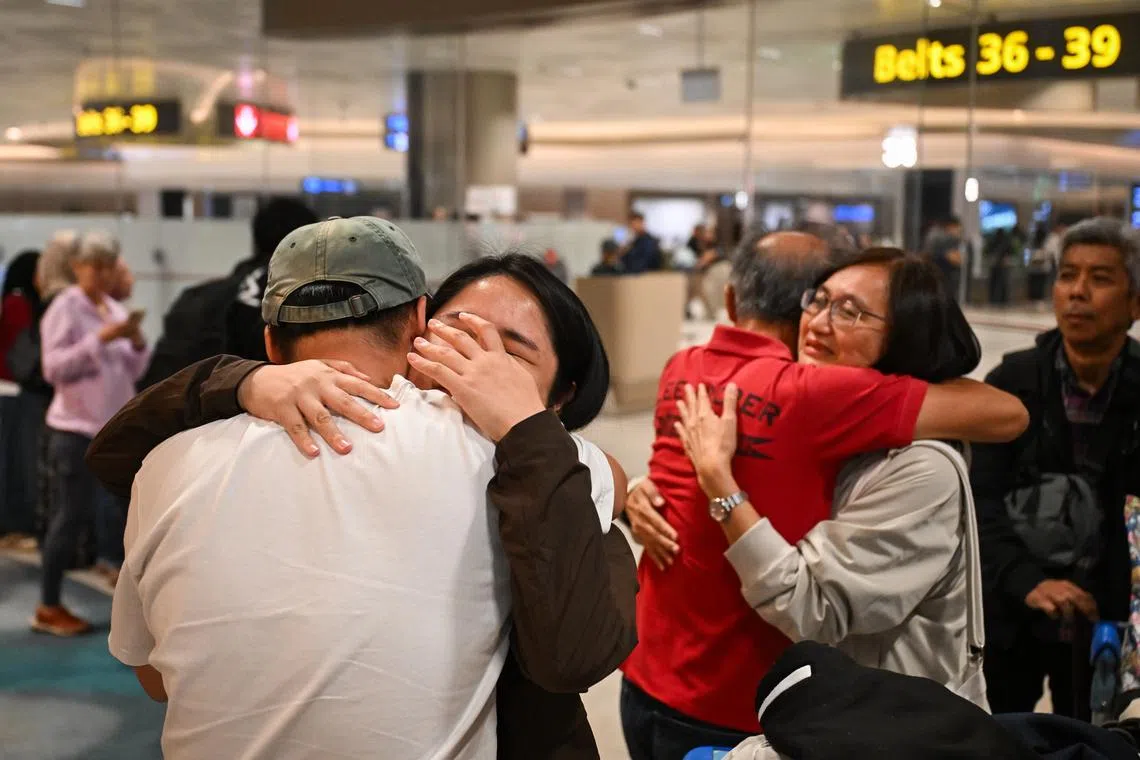 Ms Amanda Er, 31, a healthcare worker, tearing up as she is greeted by a loved one, after arriving at Changi Airport on a Republic of Singapore Air Force A330 multi-role tanker transport aircraft repatriation flight on March 11.