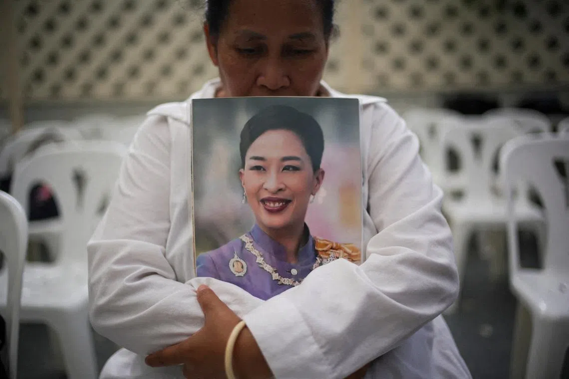 A woman reacting as she holds a picture of Thailand's Princess Bajrakitiyabha, the eldest daughter of Thai King Maha Vajiralongkorn, following the announcement of her death, outside King Chulalongkorn Memorial Hospital in Bangkok, Thailand, on June 12, 2026. 