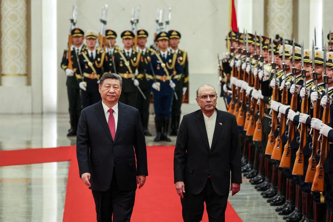 FILE PHOTO: Chinese President Xi Jinping and Pakistani President Asif Ali Zardari walk past the honour guards during a welcome ceremony at the Great Hall of the People in Beijing, China, 05 February 2025.    WU HAO/Pool via REUTERS/File Photo