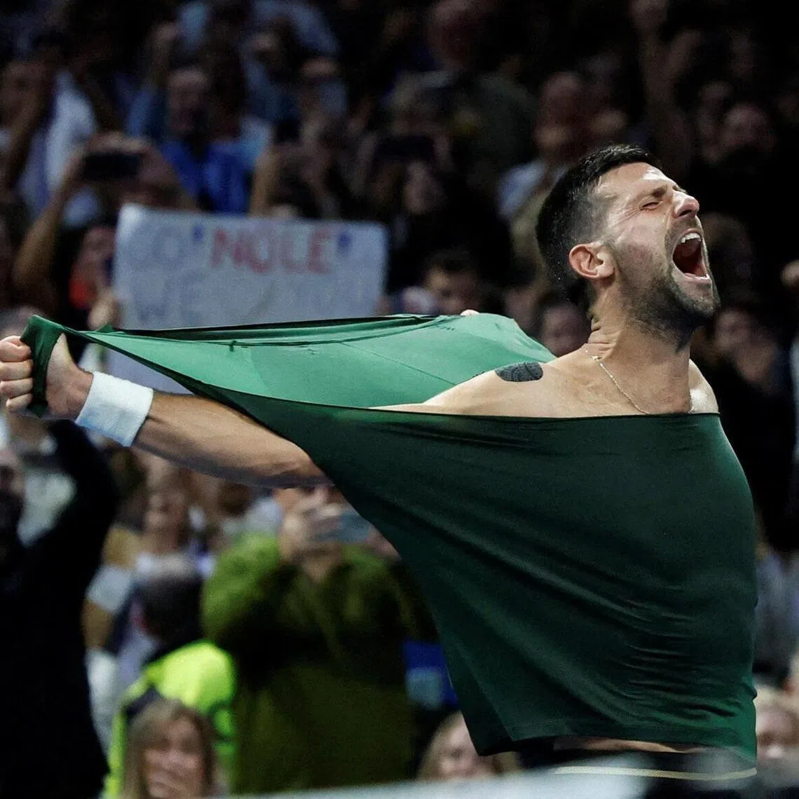 Serbia's Novak Djokovic celebrates after beating Italy's Lorenzo Musetti.