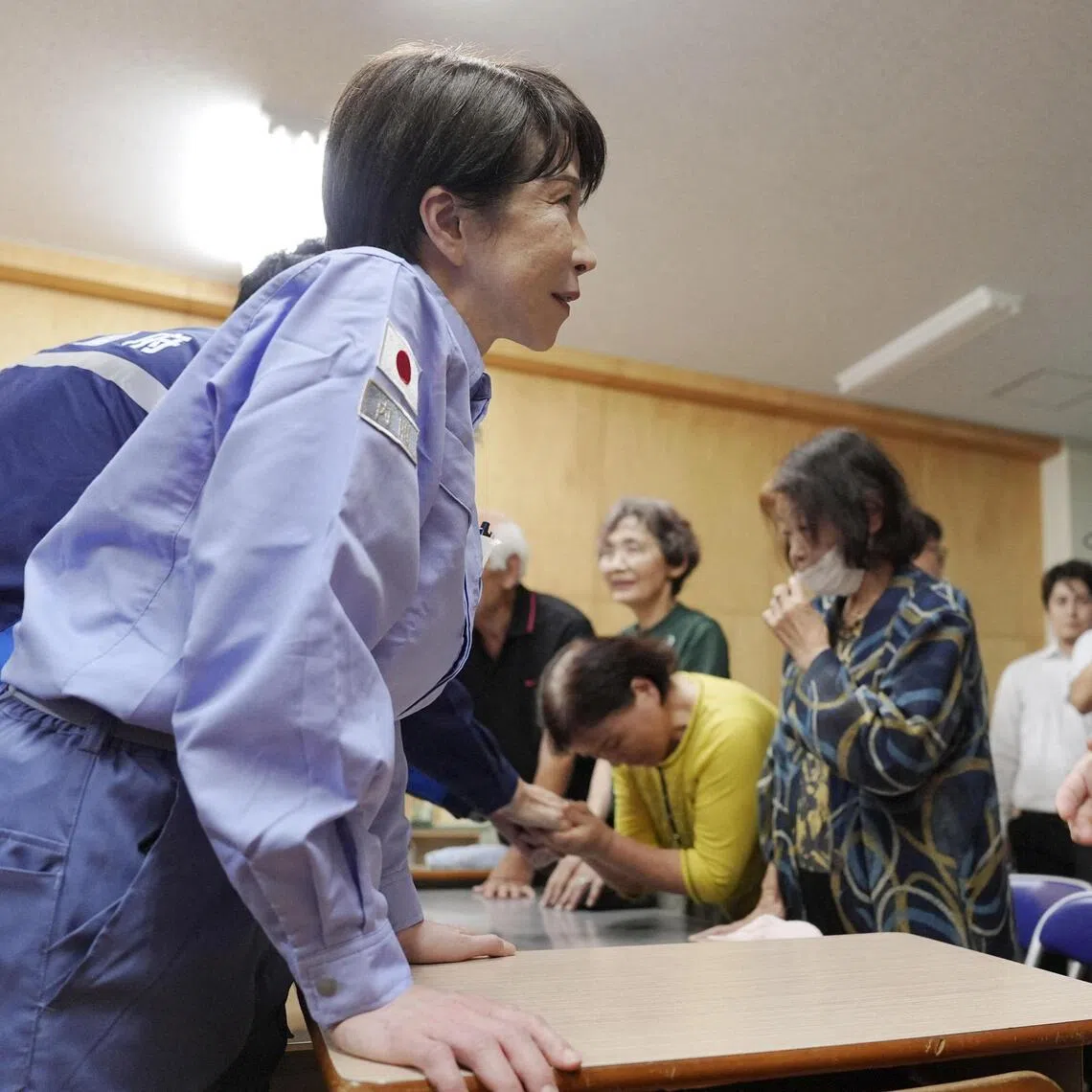 Japan’s Prime Minister Sanae Takaichi (left) talking to an evacuee as she visits an evacuation centre on Aug 3, after an earthquake with a magnitude of 7.1 struck Japan’s southern Kumamoto prefecture.