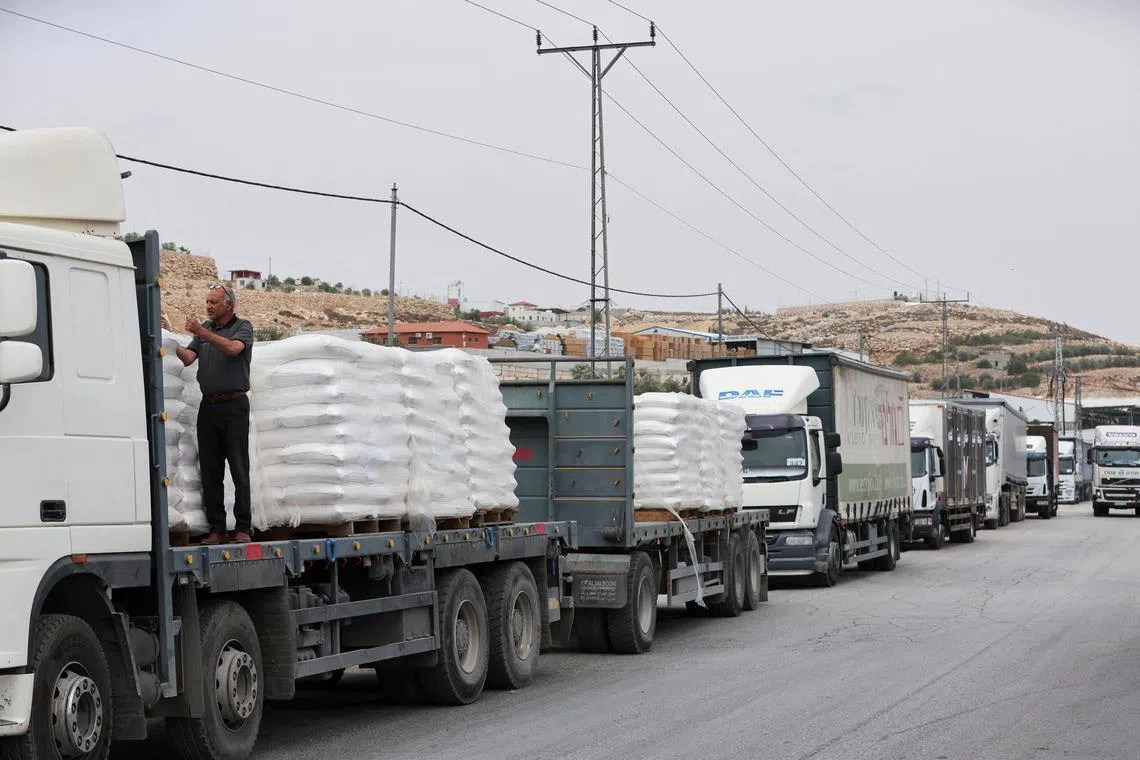 FILE PHOTO: Commercial food trucks are seen near a checkpoint near Hebron, amid the ongoing conflict in Gaza between Israel and the Palestinian Islamist group Hamas, in the Israeli-occupied West Bank May 28, 2024. REUTERS/Mussa Qawasma/File Photo