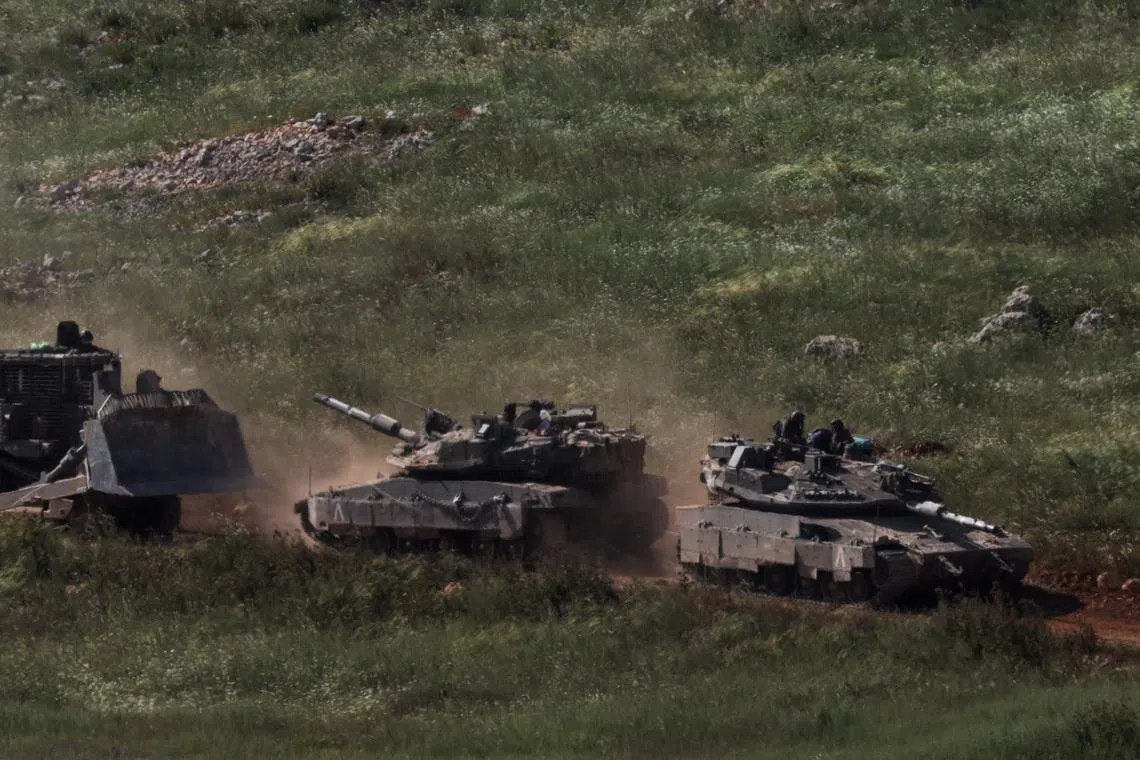 Tanks and an armoured vehicle drive in Lebanon, as seen from the Israeli side of the Israel-Lebanon border, in northern Israel, April 25, 2026.