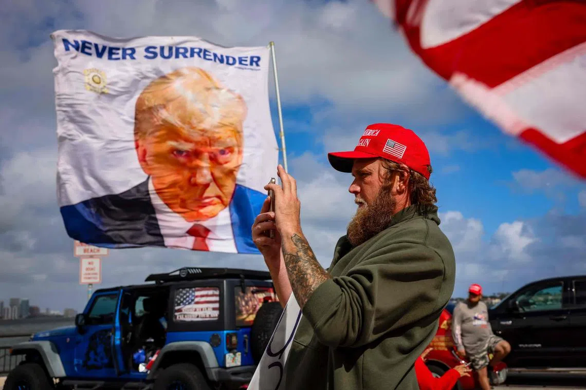A man showing support for US President-elect Donald Trump near his Mar-a-Lago resort in Florida on Dec 14.