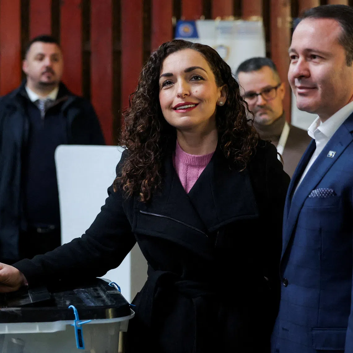 President of Kosovo Vjosa Osmani, flanked by her husband Prindon Sadriu, votes during a snap parliamentary election, nearly a year after a political deadlock that prevented the formation of a new government, in Pristina, Kosovo, December 28, 2025. REUTERS/Valdrin Xhemaj     TPX IMAGES OF THE DAY