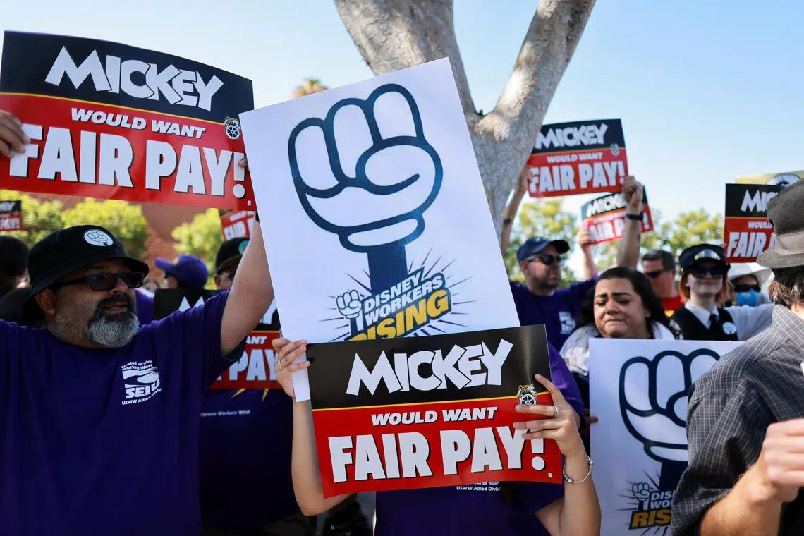 Disney employees rally outside the main entrance of Disneyland Resort in Anaheim, California, on July 17, 2024.