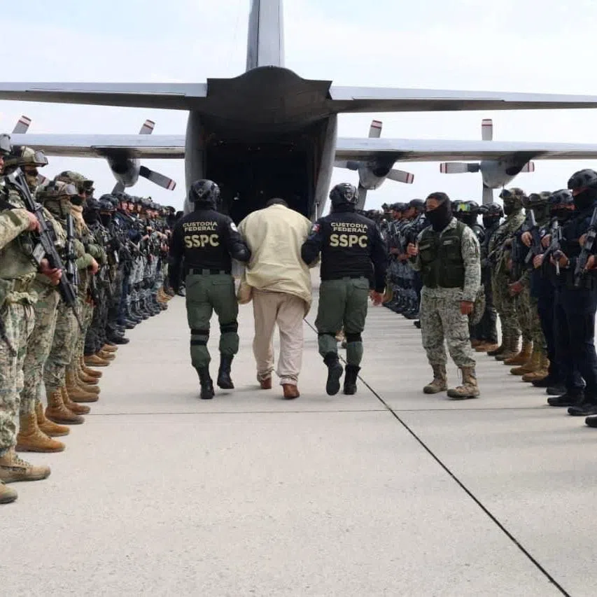 Agents of Mexico’s Secretariat of Security and Citizen Protection escort a detainee as Mexico sends another 37 alleged members of criminal organizations to the United States, at Adolfo Lopez Mateos International Airport in San Pedro Totoltepec, Mexico, in this handout photo distributed on January 20, 2026. Ministry of Security and Citizen Protection/Handout via REUTERS