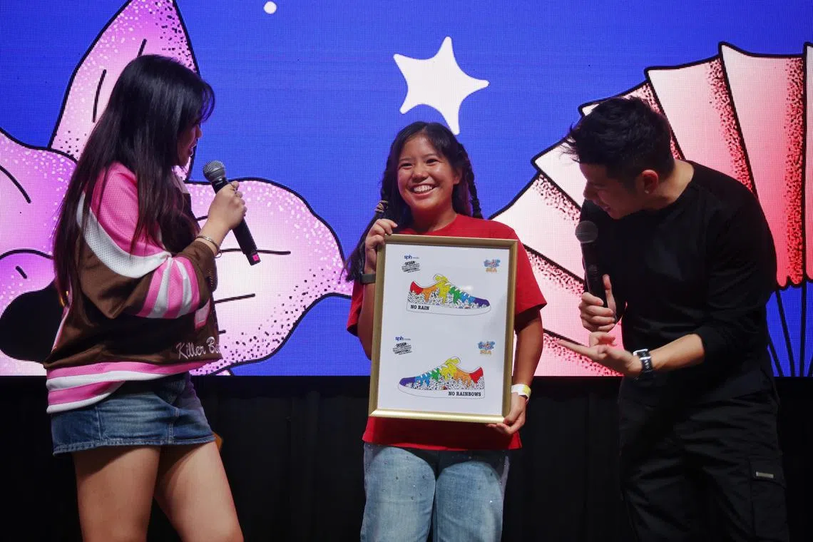 ST20250223_202503900136/akdesign24/Adrielle Koh/Jason Quah

Winner of the Design Your Sneaker competition Sarah Gwee, 19, receives a framed illustration of her design from
emcees Kiss 92 FM DJs Shawnia Seah and Tim Oh at Sneaker Con SEA on Feb 23, 2025. ST PHOTO: JASON QUAH