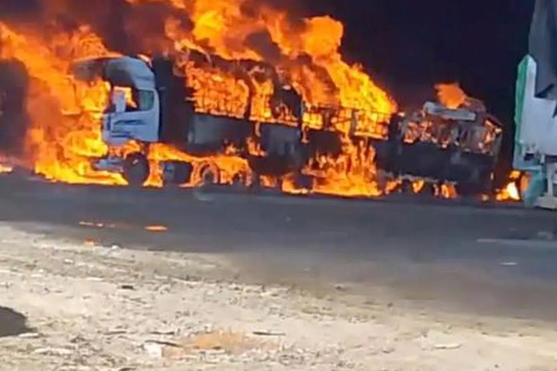 Smoke rises as a truck burns near the Myanmar-China border, near Muse, Myanmar, in this screen grab obtained from a social media video released on November 23, 2023. Video Obtained by REUTERS