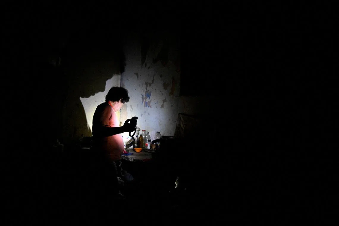 A man uses a flashlight during a blackout as Cuba's national electric grid collapsed, according to the country's grid operator, leaving around 10 million people without power amid a U.S.-imposed oil blockade, in Havana, Cuba. REUTERS/Norlys Perez